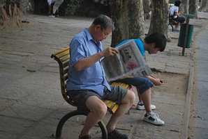 Photo of People Reading a Paper